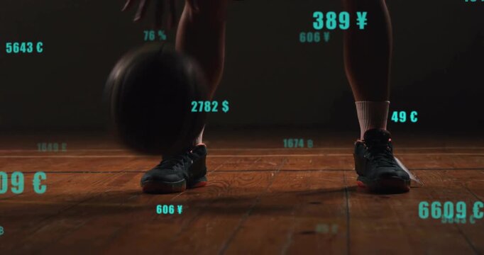 Athletic male player catching basketball on court, dribbling showcasing floating currency values