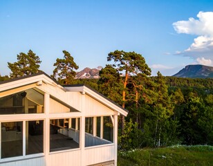 White cabin with mountain view at sunset