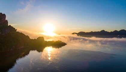 Fototapeta premium Serene Sunrise Over Misty Lake and Mountains in Tranquil Landscape