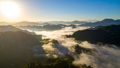 Serene Aerial View of Misty Mountains During Sunrise in Nature