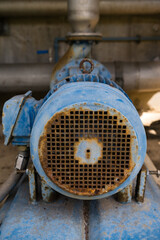 A rusty blue generator vertical