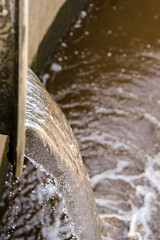 Water treatment overflow outlet vertical