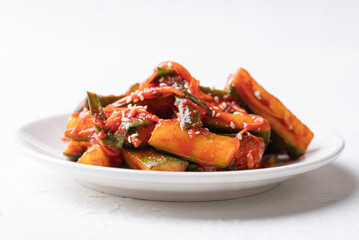 Korean kimchi cucumber on white plate, Korean side dish, Homemade food