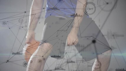 Male athlete starting dribble on court while network nodes analyzing sports performance data