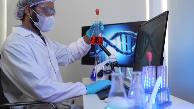 A geneticist performs microscopic analysis of a cellular sample, cross-referencing observations with genomic data displayed on a bioinformatics workstation in a biotech lab.