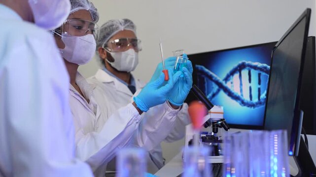 A team of geneticists collaborates on a gene sequencing analysis. The lead researcher points to a 3D model of a DNA helix, discussing specific loci with colleagues.