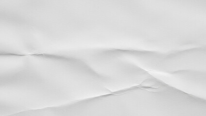 White crumpled paper surface shows wrinkles and folds for a textured background, highlighting subtle light variations and natural imperfections that create depth.