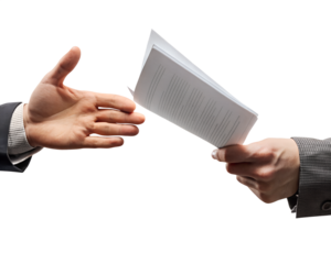 Hands exchanging documents for business deal.