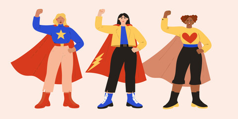 Diverse group of three women dressed as superheroes with capes and fists raised in solidarity and empowerment