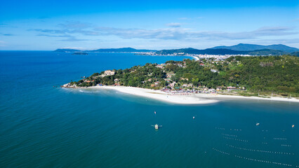 Aerial view of Jurerê Beach in Florianópolis, Santa Catarina, Brazil, showing turquoise sea, sandy shore and urban area by the coast