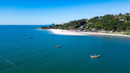 Aerial view of Jurer&ecirc; Beach in Florian&oacute;polis, Santa Catarina, Brazil, showing turquoise sea, sandy shore and urban area by the coast