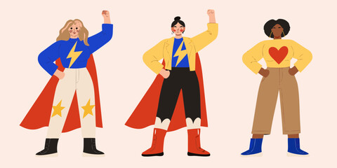 Diverse women dressed as superheroes standing confidently with fists raised © Juel