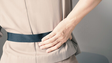 Businesswoman had severe chronic back pain that required her to use her hands to press on her back....