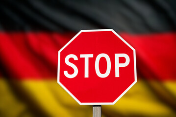 Flag of the Germany and stop sign as a symbol for the closed borders	