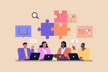 Diverse team collaborating on a project using laptops and puzzle pieces representing strategy and teamwork