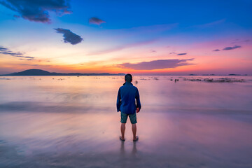 Fototapeta premium The landscape on the sea at sunrise enjoying freedom and life. This vibrant moment captures the joy of a summer vacation by the sea, filled with warmth and freedom. People travel wellbeing concept