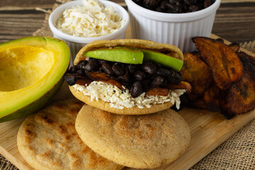 Venezuelan arepas with black beans, fried plantains, avocado, and cheese filling