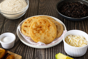 Traditional Venezuelan arepa stuffed with beans, cheese, avocado, and fried plantain