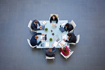 Business Team Meeting Around Round Table - Top Down View