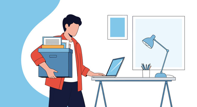 Man packing up his office desk with belongings and laptop before leaving work