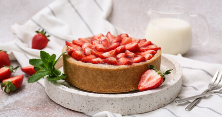 Tray with sweet strawberry tart, mint and jug of fresh milk on white background