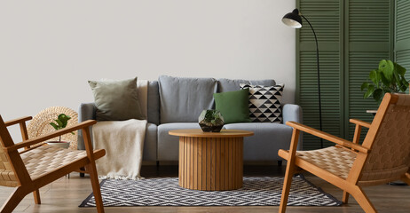 Interior of modern living room with grey sofa, armchairs and coffee table