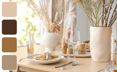 Woman setting table in dining room. Different color patterns