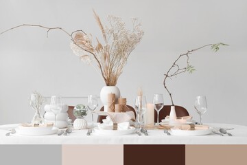 Elegant table setting with floral decor and candles in dining room. Different color patterns