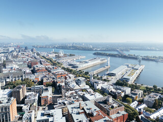 Obraz premium Drone aerial view of Montreal Old Port skyline with river in a foggy smoggy day. g