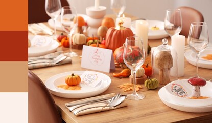 Festive table setting for Thanksgiving Day with pumpkins and candles. Different color patterns