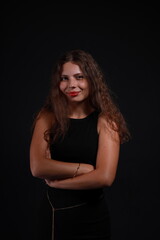 Fototapeta premium Low key portrait of pretty brunette woman in black dress