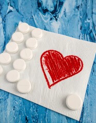 Pills and heart on napkin