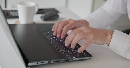 man in shirt typing on laptop keyboard in office - close up of hands - Powered by Adobe