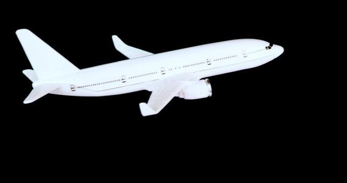 White passenger jet banking to the left isolated with alpha channel for use with aviation, travel, technology,  and business concepts.
