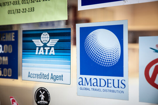 BELGRADE, SERBIA - MARCH 15, 2025: Travel-agency shows IATA Accredited Agent and Amadeus Global Travel Distribution, on ticket-selling status and connection to worldwide airline reservation network.