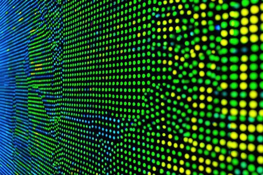 Abstract digital art of glowing dots forming a wave pattern