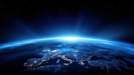 Obraz premium Stunning view of planet Earth from space showing the atmosphere illuminated at sunrise with city lights and starry night sky