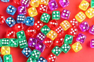 Colorful game dices on red background