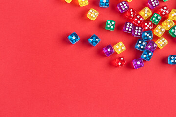 Colorful game dices on red background