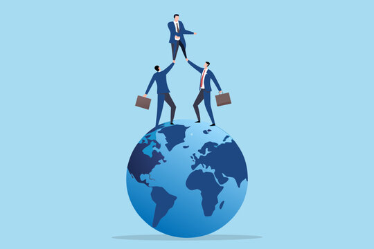 Three businessmen form a pyramid on top of the earth symbolizing global success and teamwork