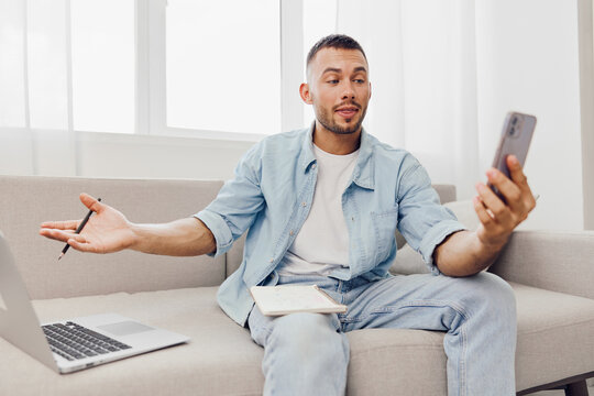 Engaged man communicating on phone, expressing emotions. Balancing work-life while navigating modern challenges of technology and mental health.