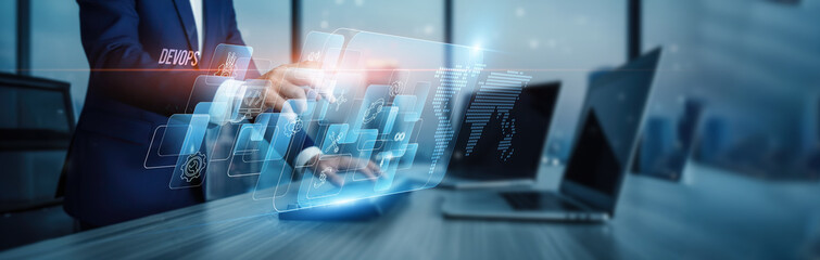 DevOps concept. Hand touching integrated DevOps platforms, workflow connection on virtual screen...