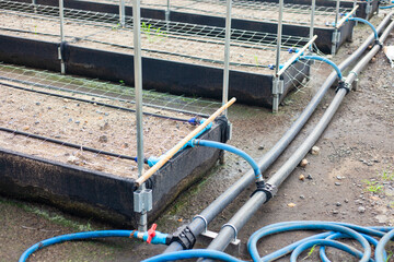 Close-up of an agricultural water management infrastructure system with pipes and valves. Modern agriculture. Maintenance of agricultural irrigation systems.