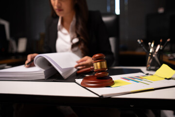 Female lawyer is working on legal documents in an office.