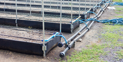 Close-up of a water pump. Agricultural water piping system. PVC pipe connectors.