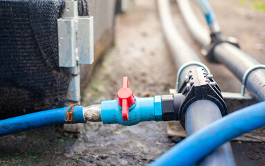 Close-up of a water pump. Agricultural water piping system. PVC pipe connectors.