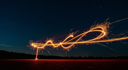 Long exposure photograph of a sparkler creating light trails against a dark night sky.