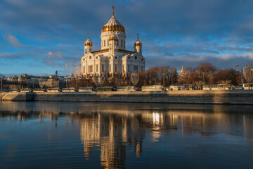 View of the Cathedral of Christ the Savior and the Patriarchal Bridge from the Beresnevskaya embankment of the Moskva River on a sunny winter day, Moscow, Russia