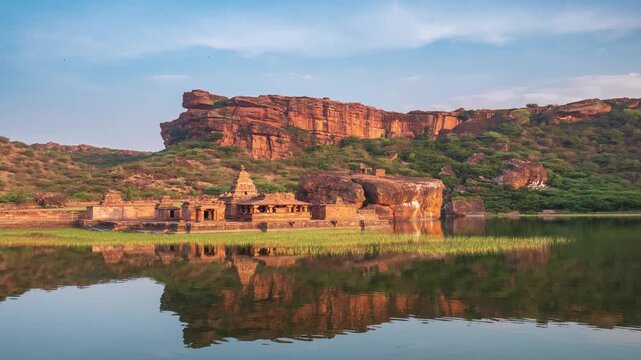 Time lapse: ancient Badami rock temple Karnataka India reflected in Agastya lake surrounded by sandstone cliffs symbolizing heritage spirituality culture serenity timelessness