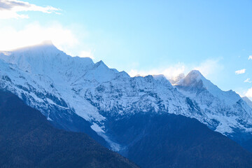 Jagged, snowy peaks loom under a cloudy sky Meili Snow Mountain Yala Snow Mountain, Sichuan, China